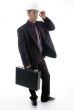 male architect in helmet holding office bag