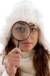 female looking through magnifying glass
