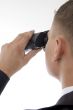 young accountant posing with binoculars