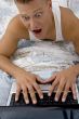 man surprised while working on laptop