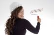 woman with architect helmet and paint brush