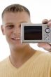 happy man holding digital camera