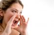 beautiful young woman bellowing someone