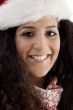 close up of young woman wearing christmas hat