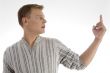 male looking at his index finger