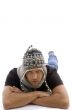 young male lying and wearing woolen cap