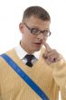 teenaged student digging his nose