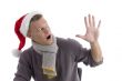 smiling young man with christmas hat showing