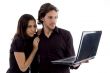 young couple looking into laptop