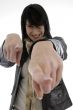 cheerful woman pointing towards camera