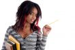 school girl posing with pencil and books