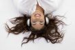 young female lying and enjoying music