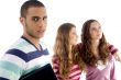 two girls holding each other and guy looking