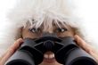 close up view of woman holding binocular