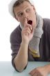 male with christmas hat putting finger in his nose