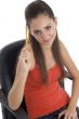 teenager girl holding pencil and looking at camera