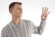 smiling man with counting hand gesture