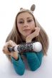 laying woman holding roller comb