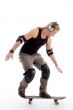 young male model balancing skateboard