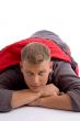 young man covered himself with red sleeping bag