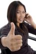 woman showing thumbs up while talking