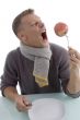 man holding apple with fork