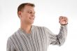 smiling man showing his fist