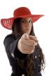 beautiful young female wearing hat pointing