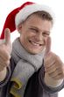 male with christmas hat showing thumb up