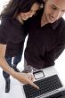 standing young couple looking into laptop