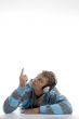 laying young man with headphone pointing upward