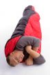 young man covered himself with red sleeping bag