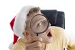 man wearing santa hat and looking through lens