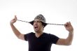 young man playing with his cap