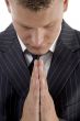 praying young businessman