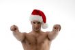 cool muscular man wearing christmas hat