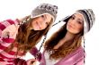 pretty girls wearing cap and looking at camera