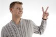 successful young man showing peace sign