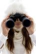 beautiful woman looking through binocular