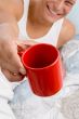 man showing coffee mug