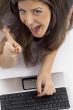 cheerful female busy with laptop
