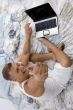 man with laptop and thumbs up