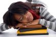 tired school girl sleeping with her books