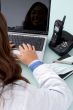 half length view of doctor working on laptop