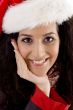 close up of smiling young woman with christmas hat