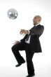  young corporate man playing with disco ball