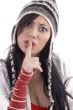 woman shushing and wearing winter cap