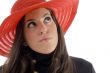 female wearing hat looking upward