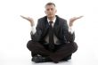 businessman doing yoga with open palms