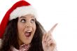 young woman with christmas hat indicating upward